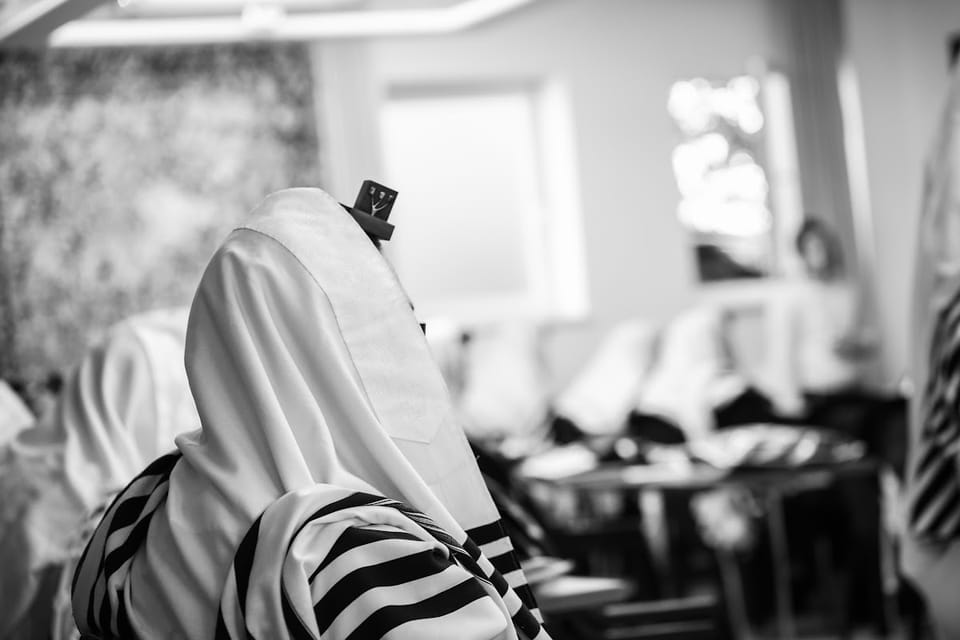 Why Do Charedim Cover Their Heads with a Tallis When Davening?
